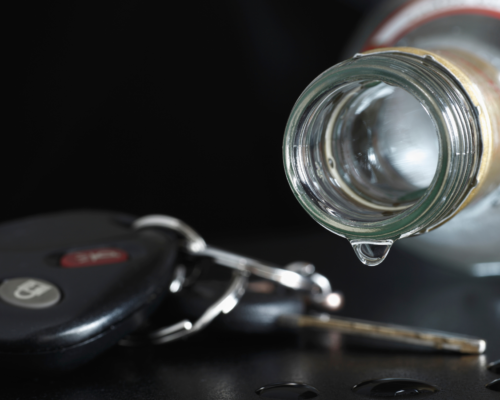 Clear liquor dripping onto car keys.